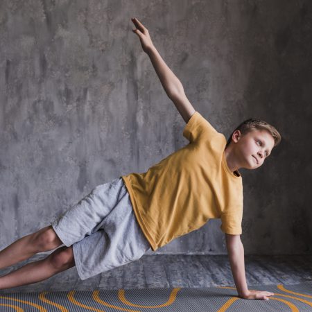 close-up-boy-doing-stretching-exercising-against-concrete-wall