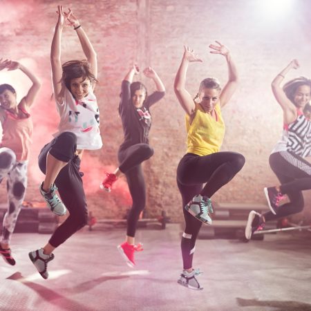 Group of fit young women dancing  and exercising