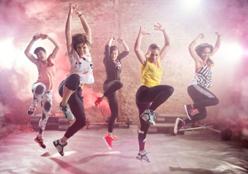 Group of fit young women dancing  and exercising