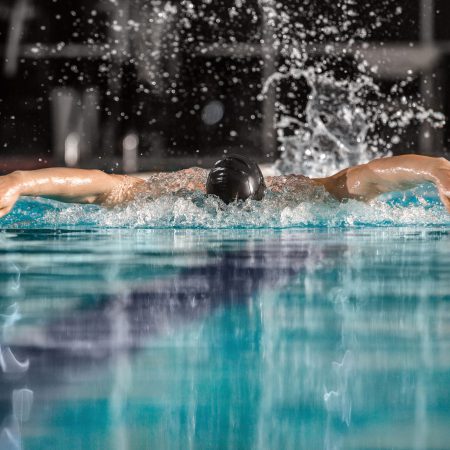 Male swimmer swimming the butterfly stroke in a pool